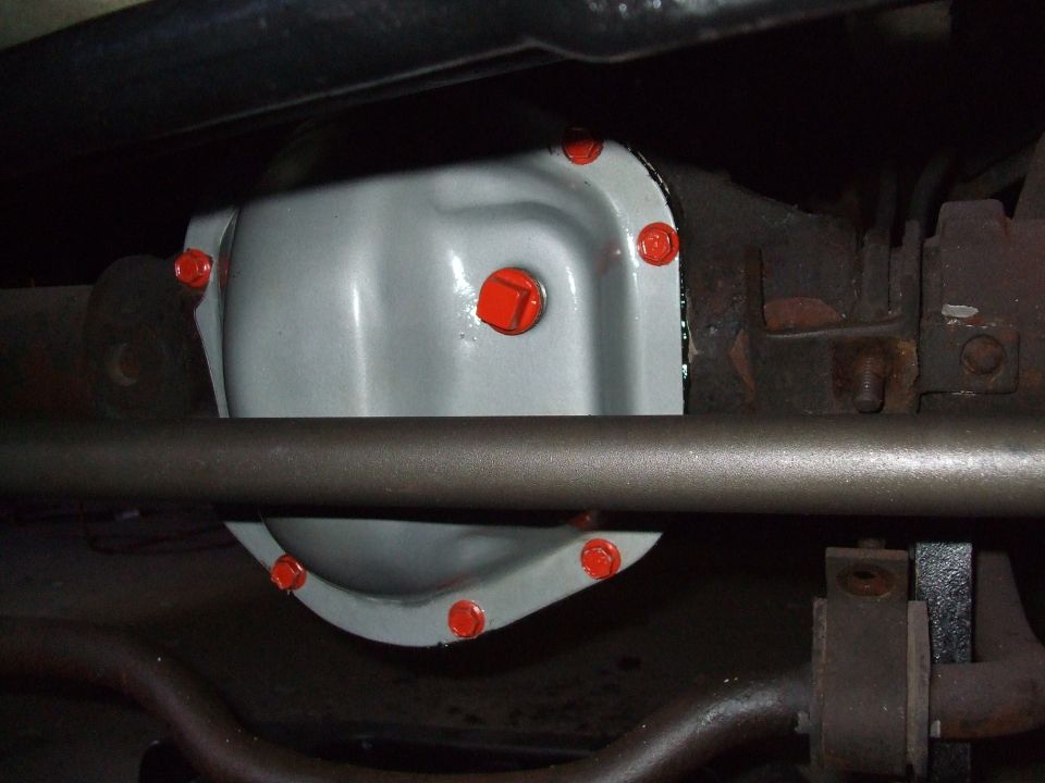 Differential cover with red bolts, viewed from below