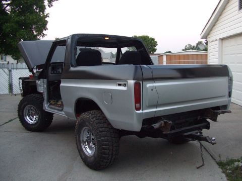 1979 Ford Bronco - This Ford Bronco appears to be undergoing some work, with its hood and doors open, revealing its interior and engine bay.