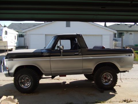 1979 Ford Bronco - This two-tone 1979 Ford Bronco is shown from the side, aftermarket wheels and a lifted suspension.