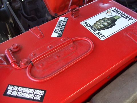 1979 Ford Bronco - A red toolbox with humorous stickers is shown, possibly in an engine bay.