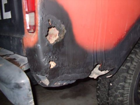 1979 Ford Bronco - This vehicle's rear quarter panel shows extensive rust and deterioration, obscuring any specific model year details.