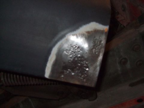 1979 Ford Bronco - This image shows a close-up of a metal panel, likely undergoing repair, with visible rust and primer.