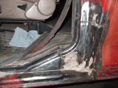 1979 Ford Bronco - Rust damage and repair work visible on the interior door frame of a red vehicle.