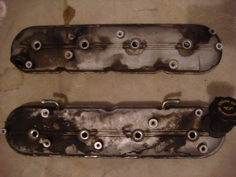Pair of removed V-style engine valve covers on a floor