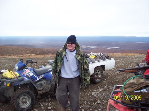 1986 Chevrolet Blazer - Man with ATVs and trailer in a remote, open landscape under an overcast sky.