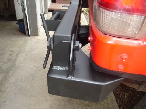 1989 Ford Bronco - Close-up of a custom rear bumper assembly mounted to a red vehicle.