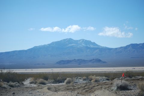 1982 Ford Bronco - Desert landscape with mountains and a bright orange marker in the foreground.