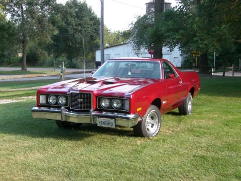 1972 Ford Ranchero - This red 1977 Ford Ranchero features a distinctive front end with quad headlights and a prominent grille.