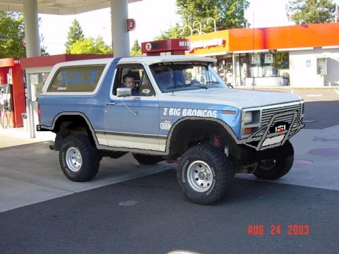1989 Ford Bronco - This modified Ford Bronco is parked at a gas station with a convenience store in the background.