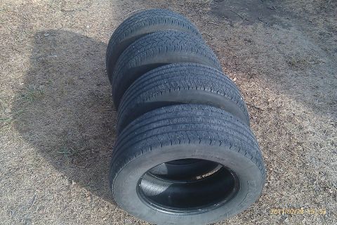 2000 Mercury Grand Marquis - A set of four tires is displayed on the ground, with the closest tire clearly visible.