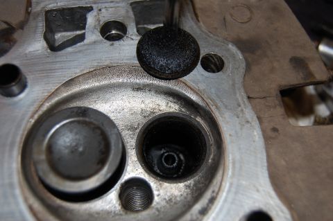 2006 Honda RANCHER - Engine cylinder head with carbon deposits on the valve and ports.