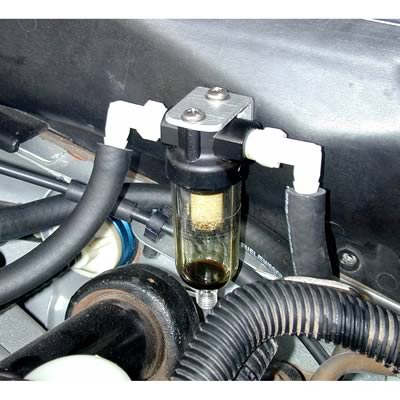 1990 Ford Bronco - This image shows a fuel filter, likely for a vehicle, with visible fluid and particulate matter collected within the filter housing.