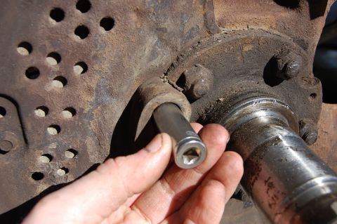 1994 Ford Bronco - Using a socket to gently tap out the ABS sensor.