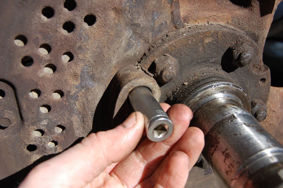 Using a socket to gently tap out the ABS sensor.