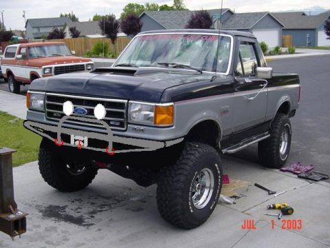 1989 Ford Bronco - This lifted pickup truck features a custom front bumper and aftermarket wheels. A date stamp indicates the photo was taken on July 1, 2003.