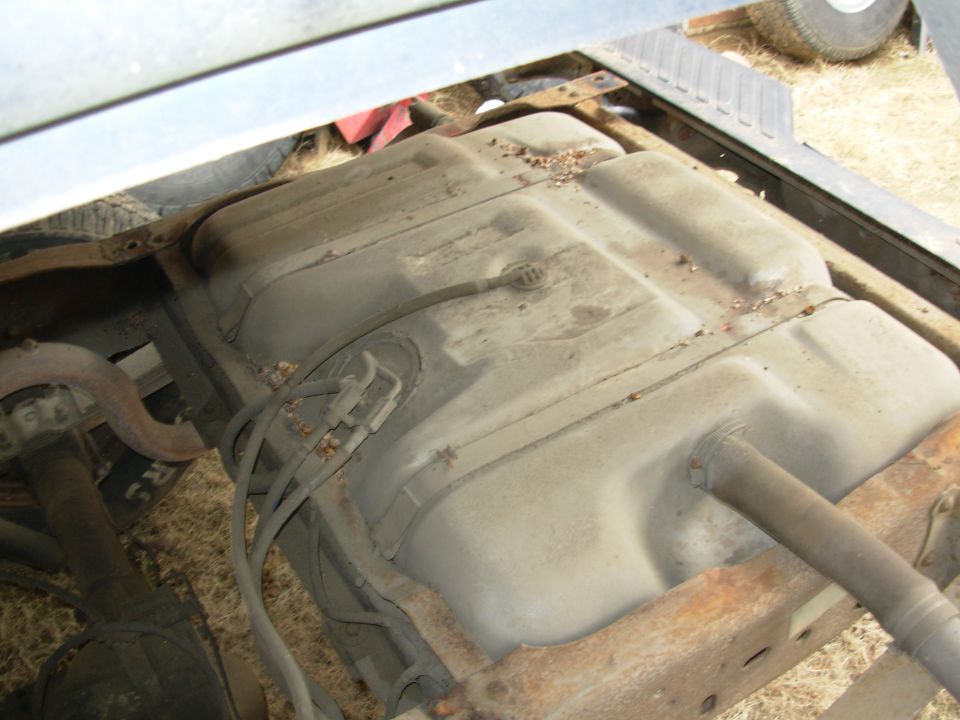 I'll vacuum & wash the tanks before opening anything.  The unusually large fuel line fitting at the tank has a check valve built in.

Go to the NEXT pic...

The hose clamp holding the rubber filler hose to the tank is 8mm (5/16").