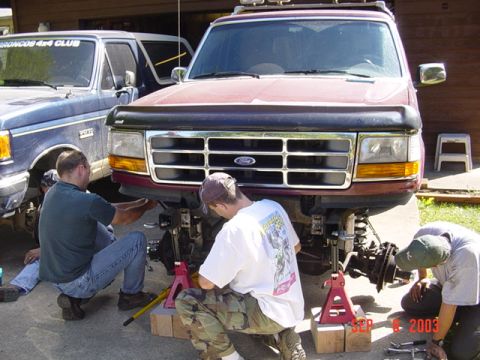 1989 Ford Bronco - People are working on the front end of a maroon Ford Bronco, with a blue Bronco parked beside it. The date SEP 6 2003 is visible.