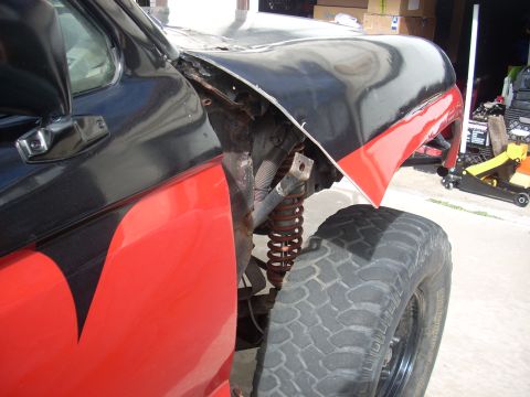 1992 Ford Ranger - A modified truck's front fender and suspension system are visible, with custom paint and off-road tire.