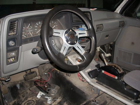 1992 Ford Ranger - The interior of a 1992 Ford Ranger shows an aftermarket steering wheel and a floor shifter.