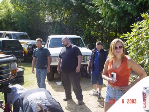 1989 Ford Bronco - A group of people stand around a white 1989 Ford Bronco in a yard.