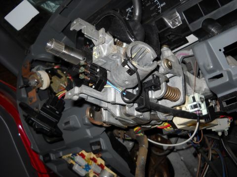 1993 Ford C-150 (Centurion Conversions) - The intricate mechanical and electrical components of a vehicle's steering column are visible in this detailed view.