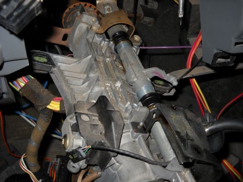 1993 Ford C-150 (Centurion Conversions) - Close-up view of a vehicle's steering column assembly, showing intricate mechanical and electrical components.