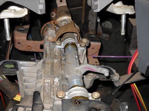 1993 Ford C-150 (Centurion Conversions) - Close-up view of a vehicle's steering column assembly, showing mechanical components and electrical wiring.