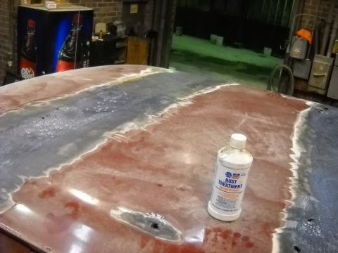 1993 Ford C-150 (Centurion Conversions) - A bottle of rust treatment sits on a car's roof, which is undergoing preparation for repairs.