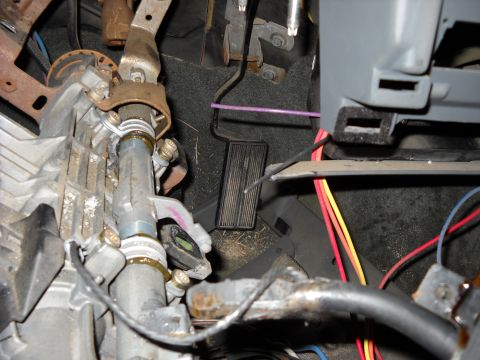 1993 Ford C-150 (Centurion Conversions) - Interior view of a vehicle's steering column and pedals, showing mechanical components and wiring.