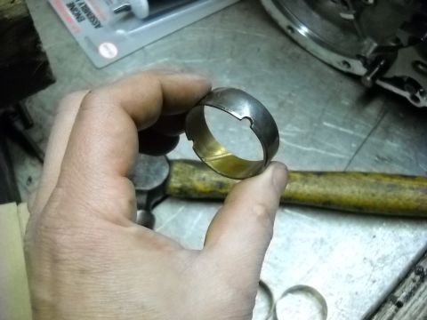 1993 Ford C-150 (Centurion Conversions) - A metal bearing ring is held up for inspection, with tools and engine parts visible in the background.