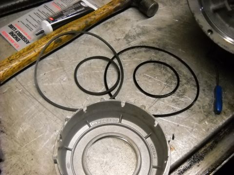 1993 Ford C-150 (Centurion Conversions) - Transmission parts and tools laid out on a workbench for an E4OD rebuild.