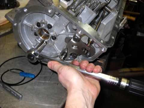1993 Ford C-150 (Centurion Conversions) - A torque wrench is being used to tighten a bolt on a transmission component during a rebuild.