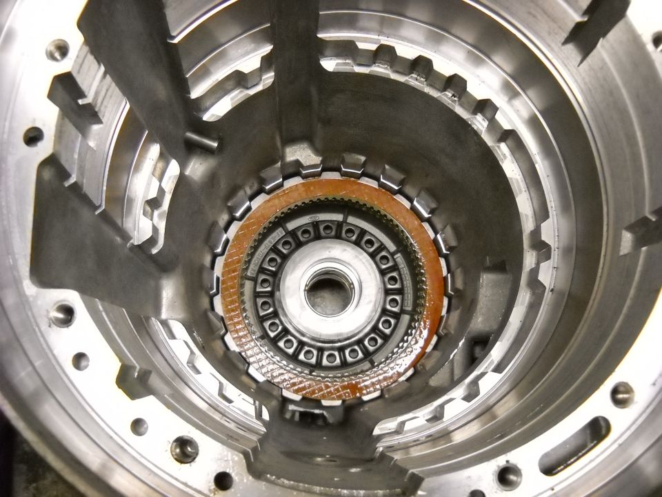 Close-up of an automatic transmission clutch pack with visible friction material and metal plates