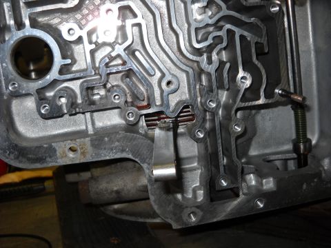 1993 Ford C-150 (Centurion Conversions) - Internal view of an automatic transmission valve body, showing intricate hydraulic passages.
