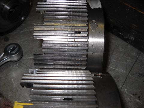 1993 Ford C-150 (Centurion Conversions) - Damaged transmission clutch pack components are laid out on a workbench, with a ratchet tool visible to the side.