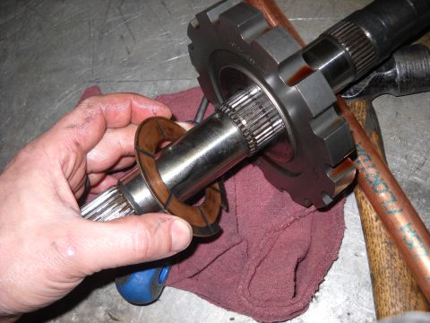 1993 Ford C-150 (Centurion Conversions) - Close-up of a transmission component being handled, likely during a rebuild.