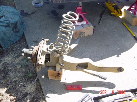 1989 Ford Bronco - A disassembled suspension component, likely from a truck or SUV, is shown with a coil spring and brake assembly.