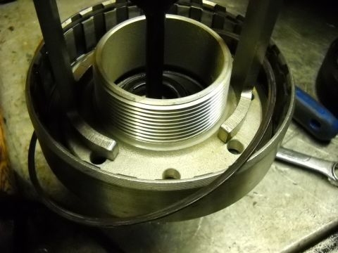 1993 Ford C-150 (Centurion Conversions) - Close-up of a transmission component with a tool engaged, likely during a rebuild process.