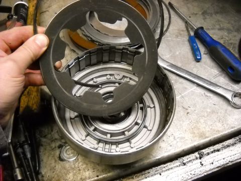 1993 Ford C-150 (Centurion Conversions) - Disassembled automatic transmission components and tools on a workbench.