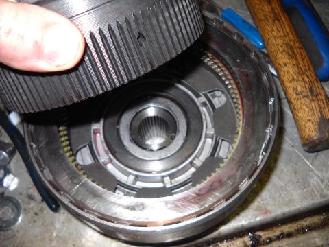 1993 Ford C-150 (Centurion Conversions) - A close-up view of a disassembled transmission component, with tools nearby.
