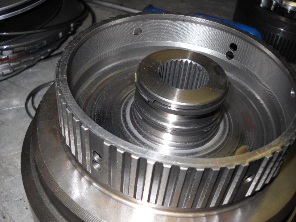 Close-up of a splined shaft inside a toothed metal ring, likely a transmission component