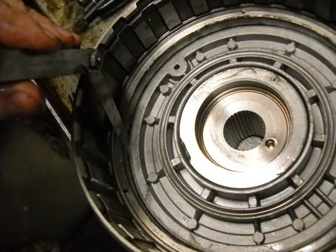 1993 Ford C-150 (Centurion Conversions) - A mechanic uses a tool to measure the clearance on a component within an automatic transmission.