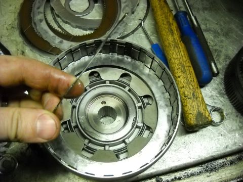1993 Ford C-150 (Centurion Conversions) - Disassembled transmission clutch pack with tools on a workbench.