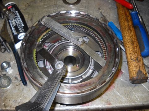1993 Ford C-150 (Centurion Conversions) - Feeler gauges are used to measure clearances on a transmission part, with assembly lube nearby.