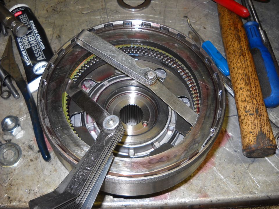Transmission component with feeler gauges and assembly lube tube on a workbench