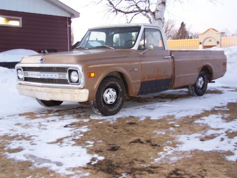 1969 Chevrolet C/K Pickup - Brown 1969 Chevrolet C/K Pickup truck with a white roof, seen in a snowy environment.