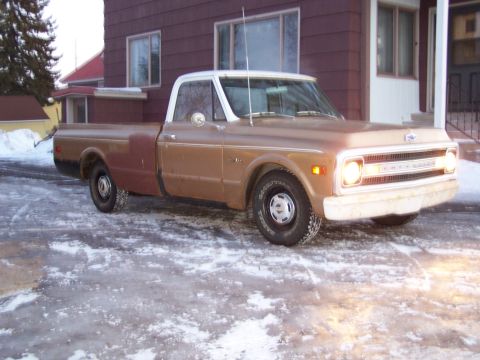 1969 Chevrolet C/K Pickup - A classic 1969 Chevrolet C/K Pickup truck sits parked on a wet, icy driveway with snow on the ground.