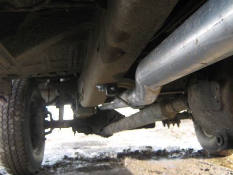 1972 Ford F-250 - The undercarriage of a truck shows a large exhaust pipe and rear axle, suggesting a model year around 1970.