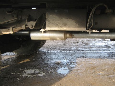 1972 Ford F-250 - A close-up view of the undercarriage of a truck, focusing on the exhaust system and suspension components.
