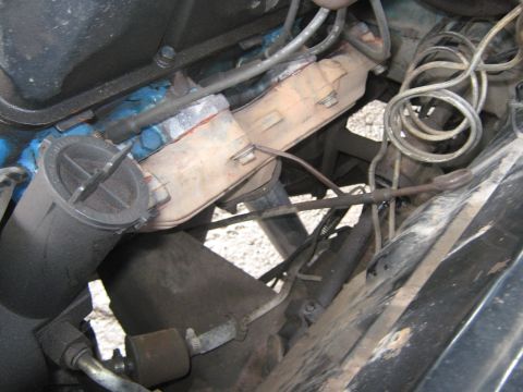 1972 Ford F-250 - Close-up view of the engine compartment of a 1972 Ford F-250, highlighting the exhaust manifold and a filter component.